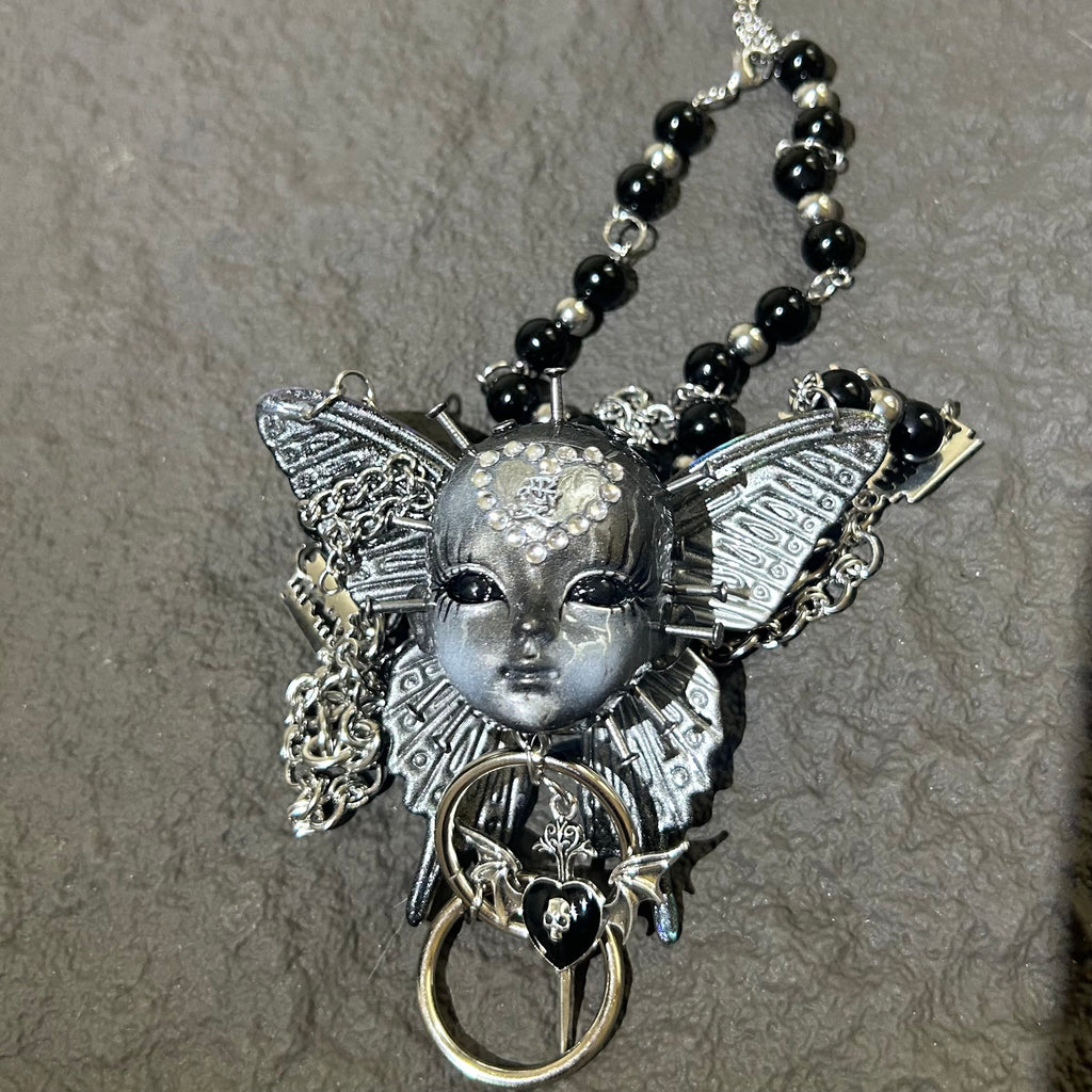 Silver Metallic Butterfly Doll Face Necklace with Rhinestone Heart & Winged Skull Charm