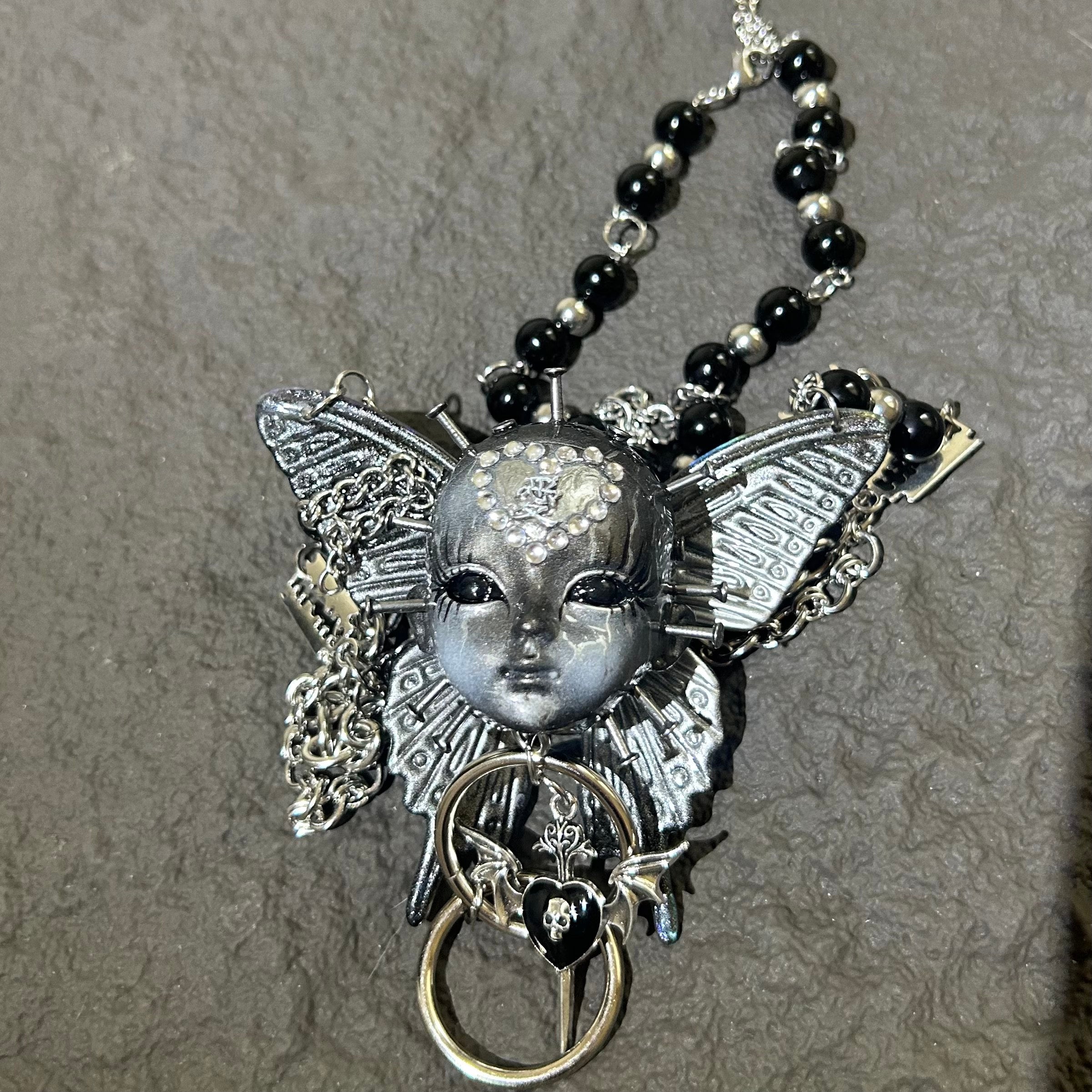 Silver Metallic Butterfly Doll Face Necklace with Rhinestone Heart & Winged Skull Charm