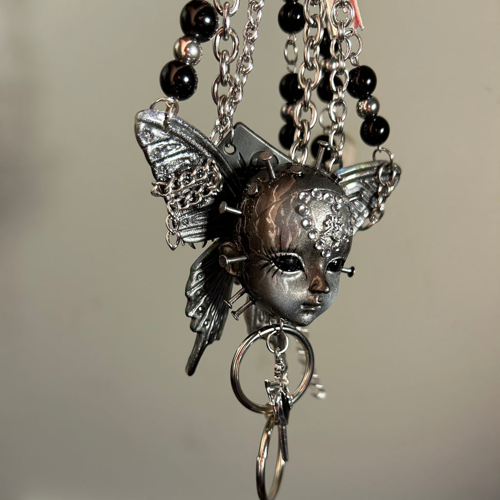 Silver Metallic Butterfly Doll Face Necklace with Rhinestone Heart & Winged Skull Charm