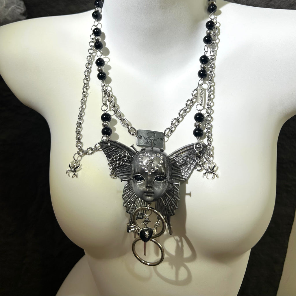 Silver Metallic Butterfly Doll Face Necklace with Rhinestone Heart & Winged Skull Charm