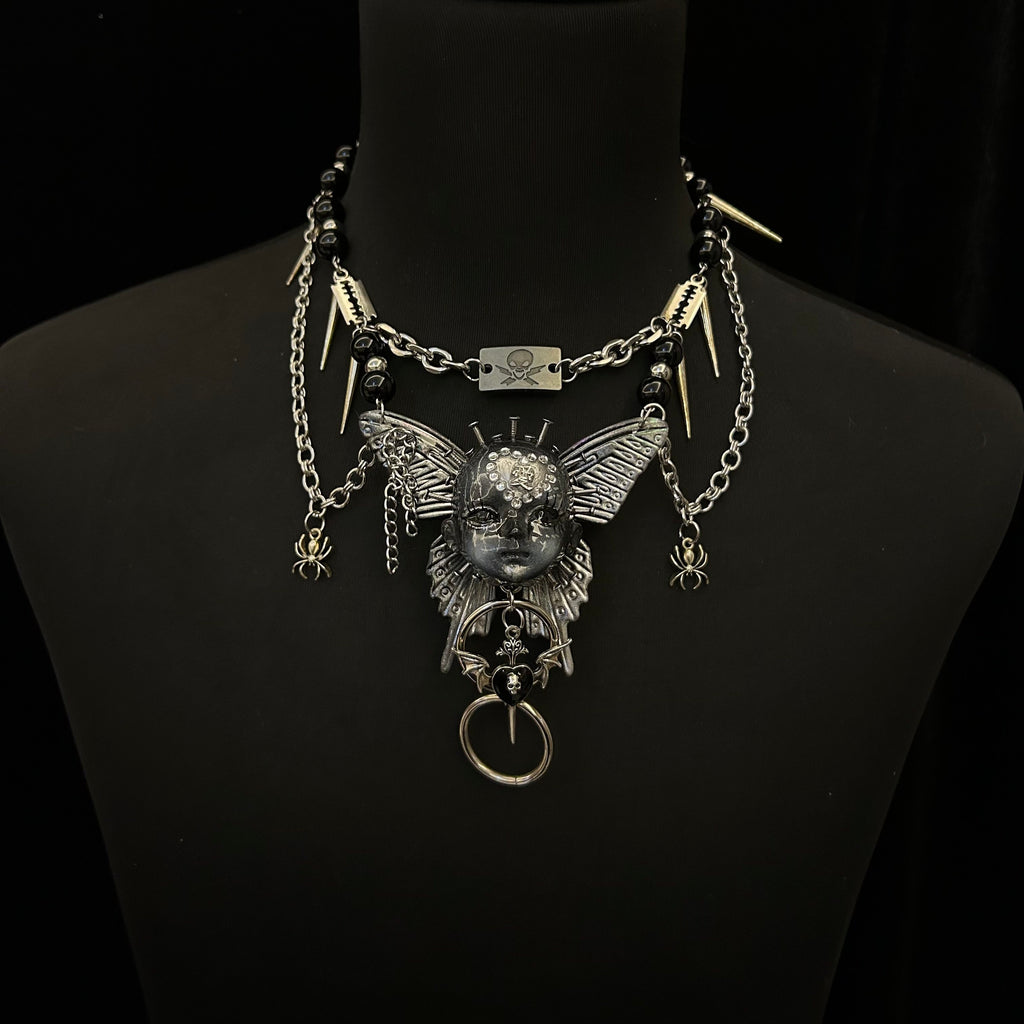 Silver Metallic Butterfly Doll Face Necklace with Rhinestone Heart & Winged Skull Charm