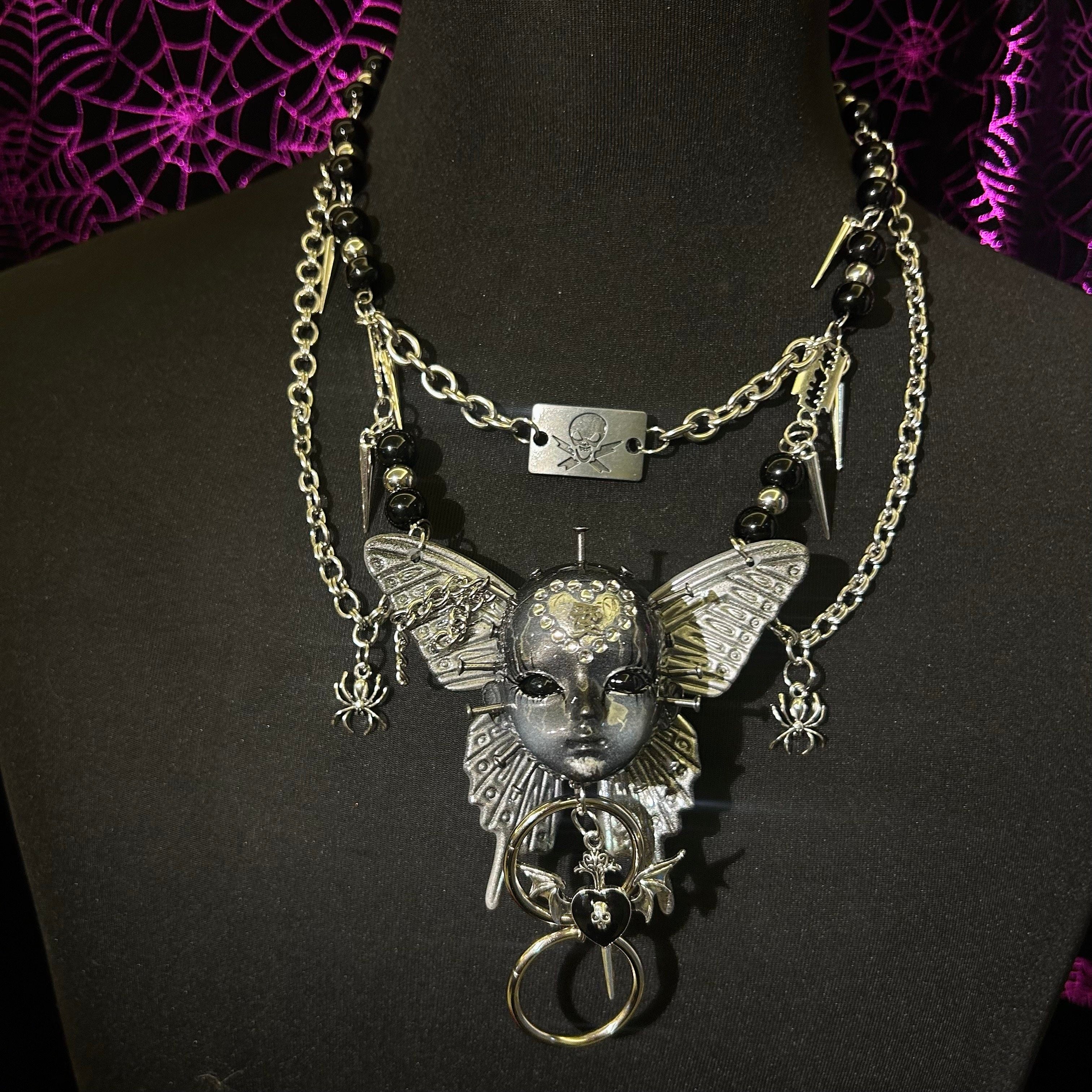 Silver Metallic Butterfly Doll Face Necklace with Rhinestone Heart & Winged Skull Charm