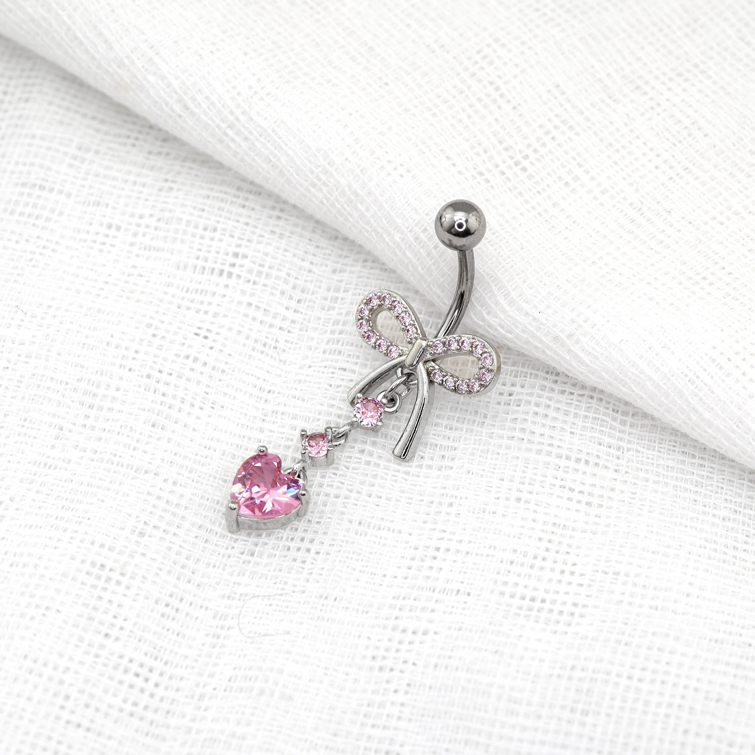 Heart-shaped CZ bow tie Dangle Belly Ring - Heart-shaped CZ bow tie Dangle Belly Ring - pink-1 by CRUXJEWELRY