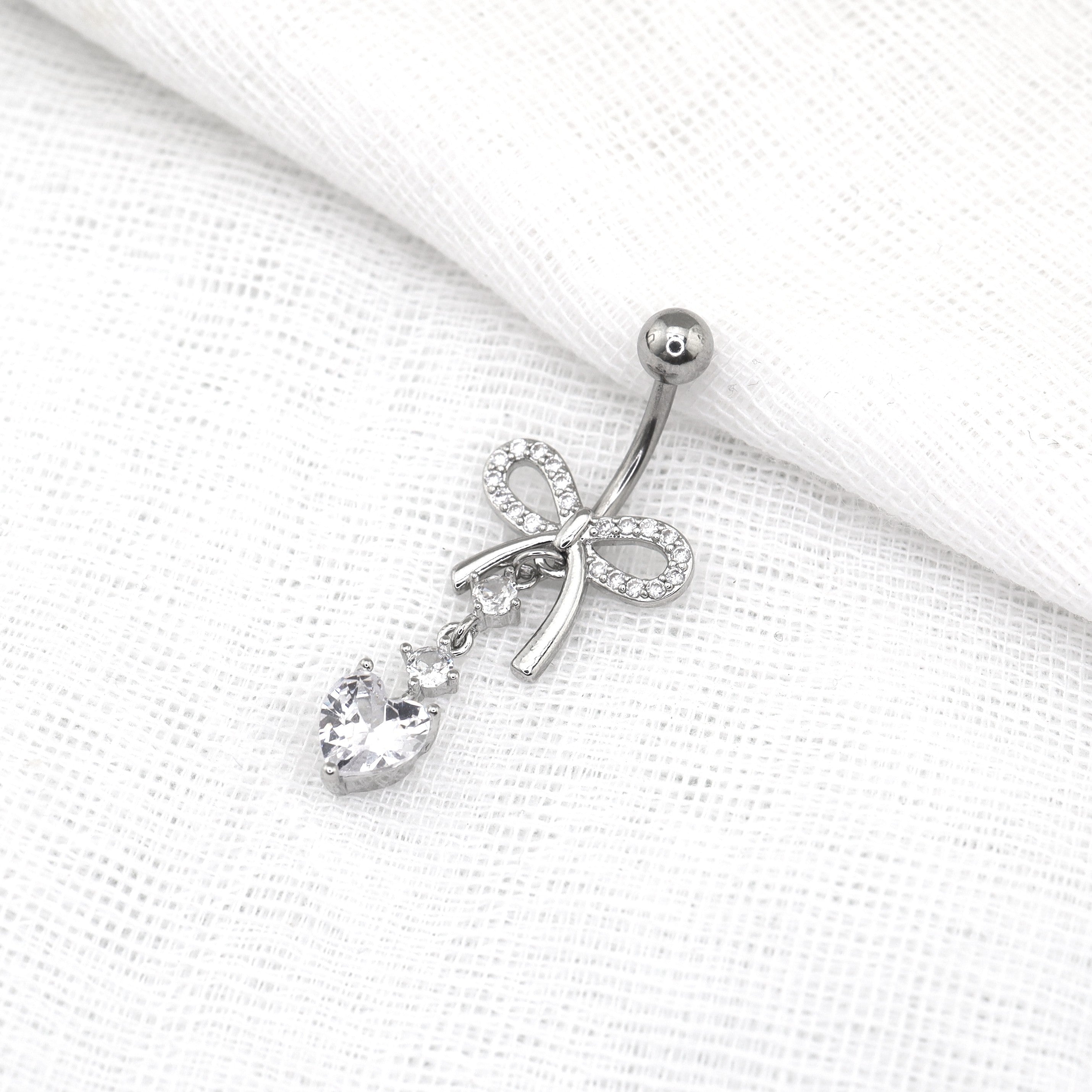 Heart-shaped CZ bow tie Dangle Belly Ring - Heart-shaped CZ bow tie Dangle Belly Ring - radiant-white by CRUXJEWELRY