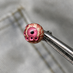 Pink Thousandfold Omen multi-eye piercing top held in tweezers