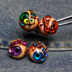 Thousandfold Omen group with green and red eye tops held in tweezers