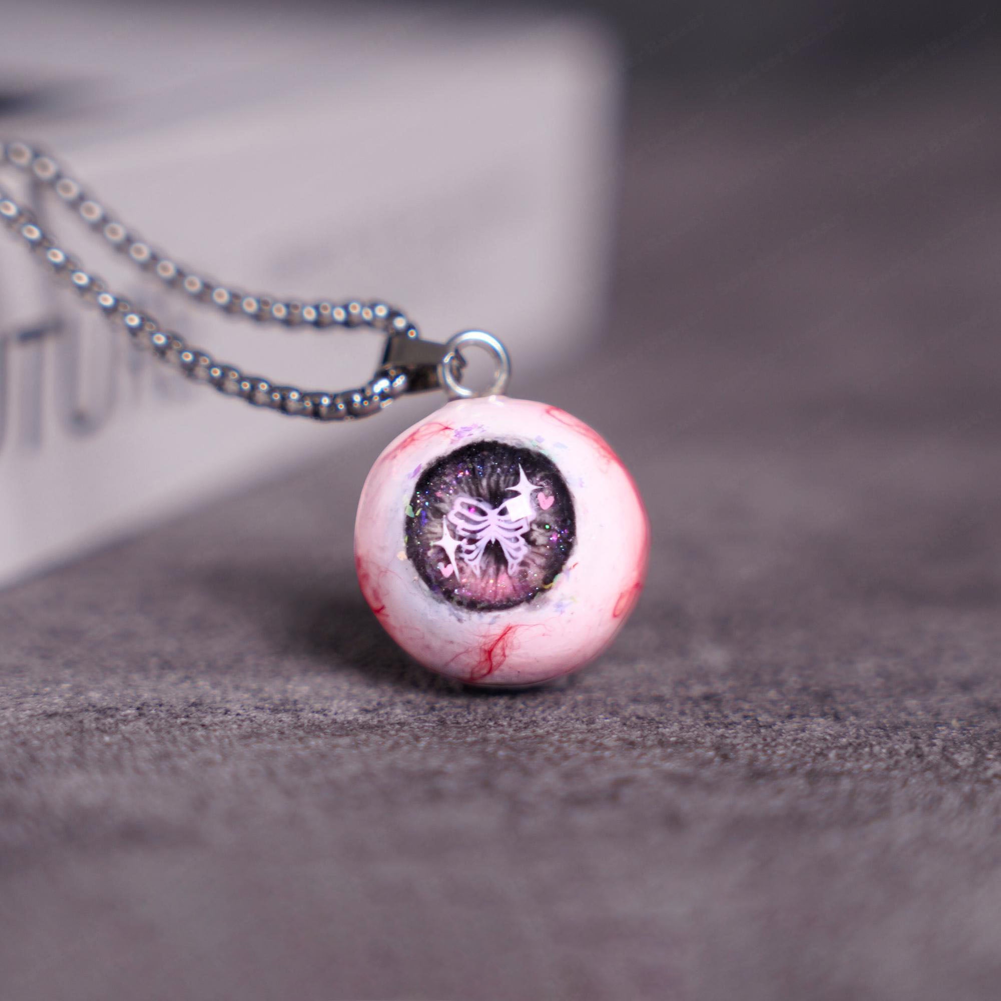 "Pretty Creepy" Coquette Bow Eyeball Necklace - Pink Glitter Ribbon Pupil