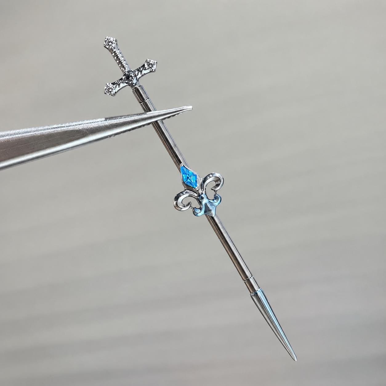 Fleur-de-Lis Sword titanium industrial barbell, detail view 6