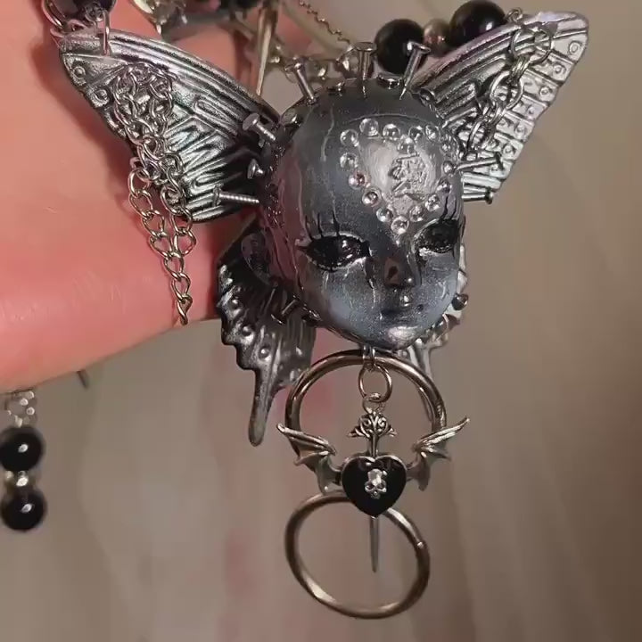 Silver Metallic Butterfly Doll Face Necklace with Rhinestone Heart & Winged Skull Charm